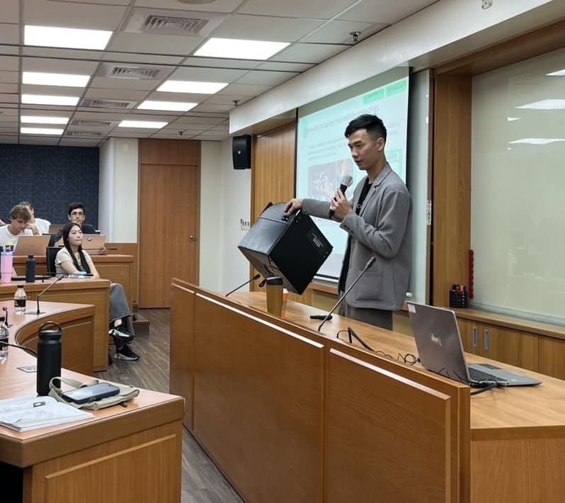 Chris Chou, Co-Founder & CSO of PackAge+, demonstrates the firm’s reusable packaging to students, highlighting how circular materials and digital tracking turn e-commerce waste into a sustainable logi